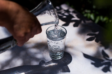 Action of pouring water in a glass. Concept of health and healthy food.