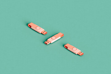 three pink flashdrives