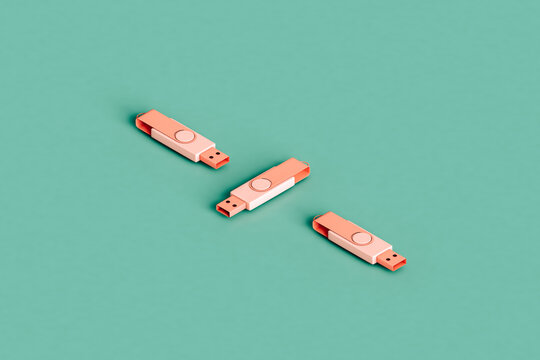 three pink flashdrives