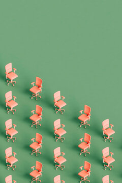 many pink office chairs on green background