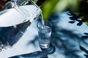 Action of pouring water in a glass. Concept of health and healthy food.