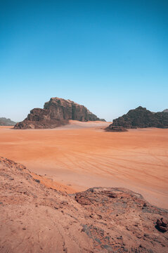 Scenic View Of Desert Against Clear Blue Sky