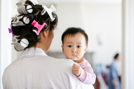 Bride Holding Baby Niece While She Gets Ready for her Wedding