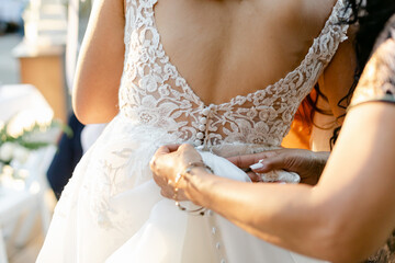 Mother Bustling back of Bride's Wedding Dress