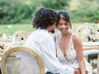 bride and groom sitting by a decorated table on their wedding day