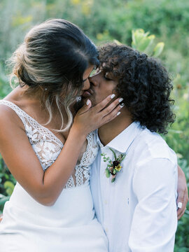 Young Woman Holding The Face Of Her New Husband And Kissing Him