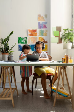 Children using tablet in study room