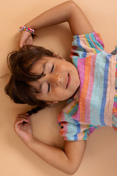 Adorable little girl lying on the floor portrait