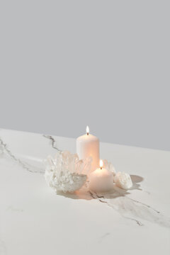 Crystals and burning candles on marble background