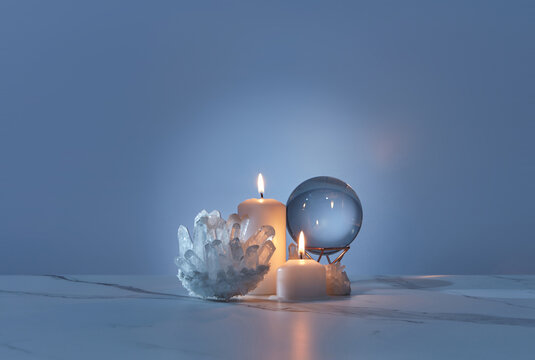 Quartz crystals, burning candles and glass ball