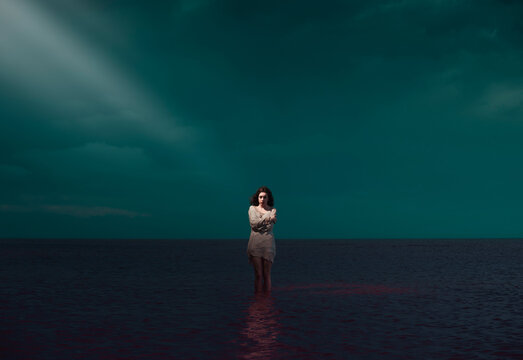 Magical portrait of standing woman on surreal scenery