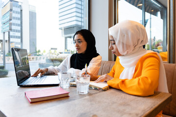 Two Muslim Businesswoman With Laptop.