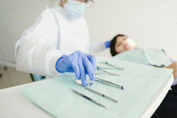 female dentist examining child teeth in dentist's office