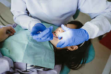 Dentist Adjusting Braces To Patient