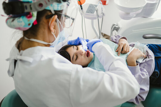 Dentists During A Dental Intervention With A Patient