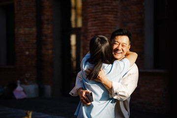 Couple hugging each other on street