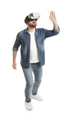 Emotional man using virtual reality headset on white background