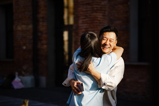 Couple hugging each other on street 