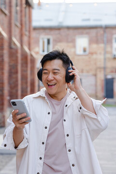 Guy in earphones choosing song in phone 