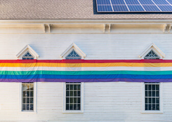 Freedom of Choice gay pride banner flag on building with solar panel 