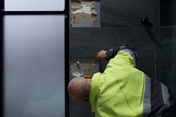 Tiling repairing broken bathroom tiles