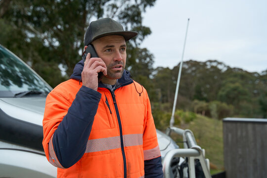 Foreman Speaking With With Work Crew On Phone