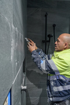 Tiler repairing grout
