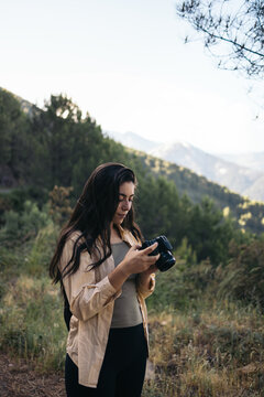 Photographer looking at the landscape photos she has taken