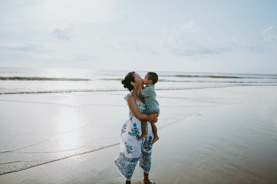 Mother and Child Sharing a Kiss on the beach