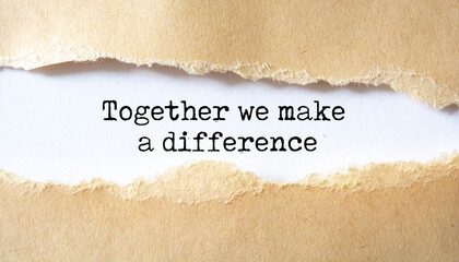 Together We Make A Difference appearing behind torn paper. Business concept