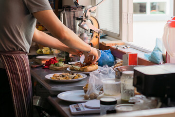 Hands of an unrecognizable person preparing food in a kitchen.