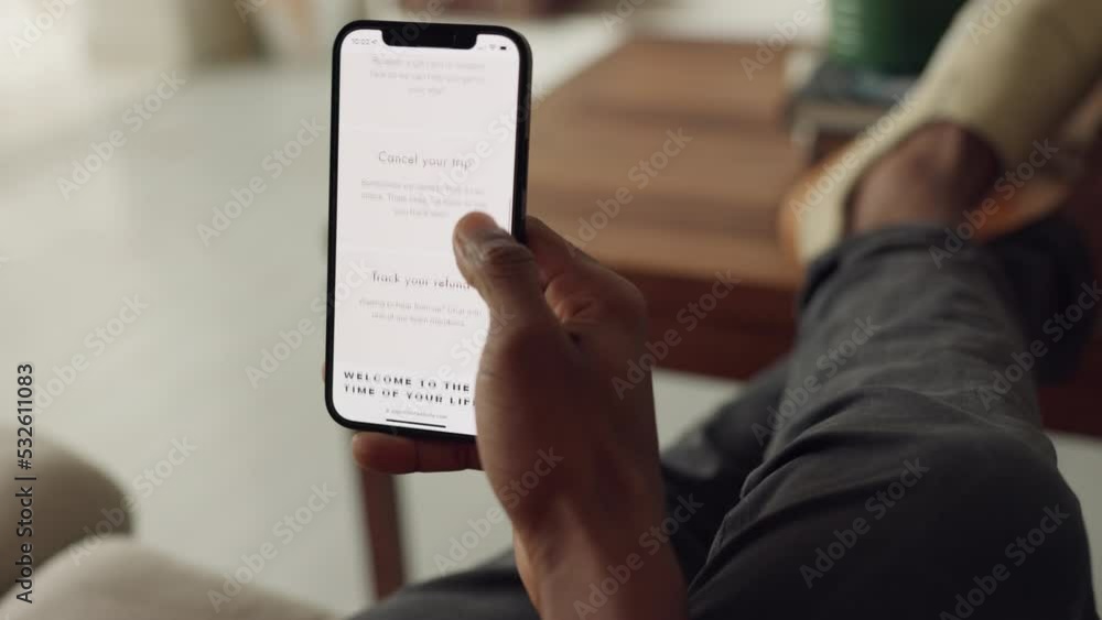 Poster Hand, phone and bucket list with a man on the search for an idea for a trip on an app in his home living room. Hands, mobile and connectivity with a male looking for a holiday or travel destination