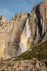 Fototapeta premium Low Angle View Of Rock Formations And A Rainbow In A Waterfall