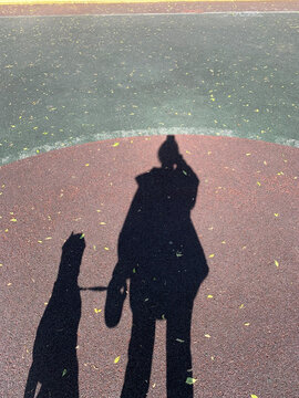 Shadow of woman and her dog