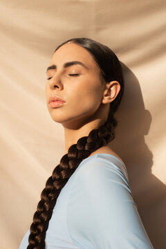 Portrait of long haired brunette with closed eyes
