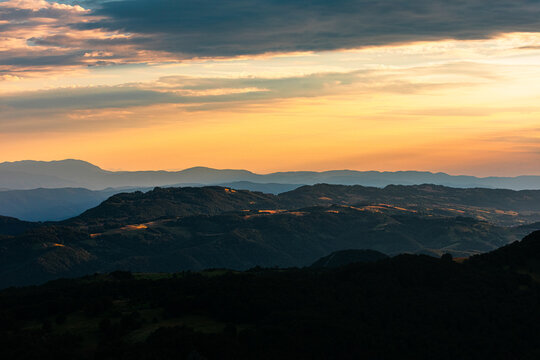 Sunset Over Hills And Mountains.