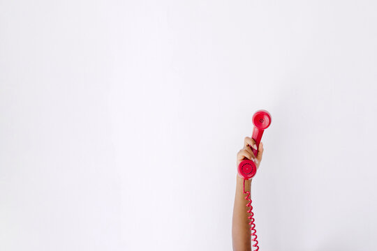Woman showing red telephone handset
