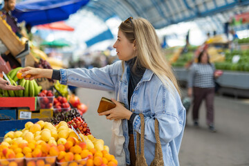 Woman buying fresh apricots