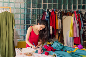 seamstress making notes in a notebook
