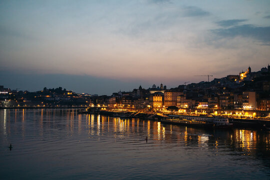 Cityscape of the city of Porto and the Douro riverside at night - Powered by Adobe