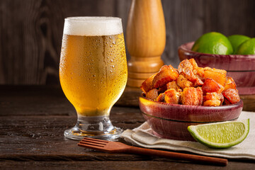 Pork rinds (torresmo) with beer, typical Brazilian food.