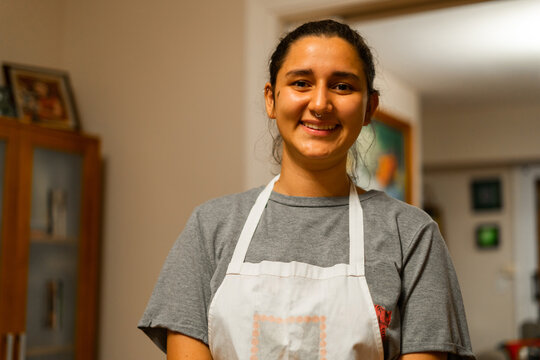 Latina woman with apron at home