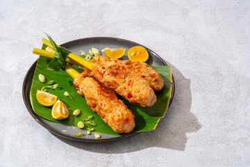 sate lilit is a satay variant in Indonesia, originating from Balinese cuisine. This satay is made from minced chicken and spiced minced meat is wound around lemongrass sticks then grilled on charcoal
