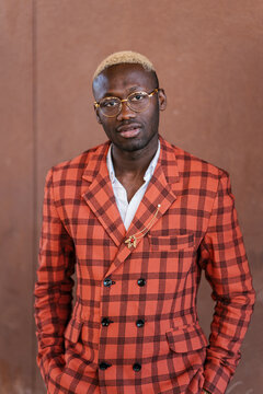 Fashionable black guy in trendy suit looking at camera