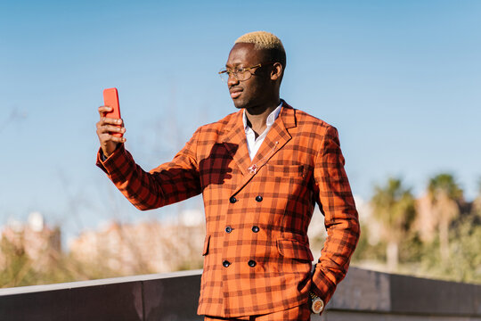 Fashionable Black Guy Taking Selfie In City Park