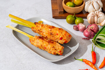 sate lilit is a satay variant in Indonesia, originating from Balinese cuisine. This satay is made from minced chicken and spiced minced meat is wound around lemongrass sticks then grilled on charcoal