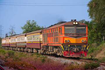 Obraz premium Passenger train by diesel locomotive on the railway.