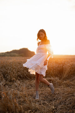 Female model in beautiful dress posing during sunset 