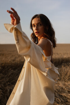 Girl in linen clothes standing among nature 