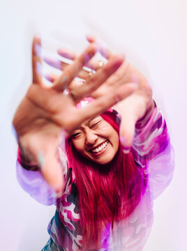 Cheerful chinese woman with colorful jacket looking at camera
